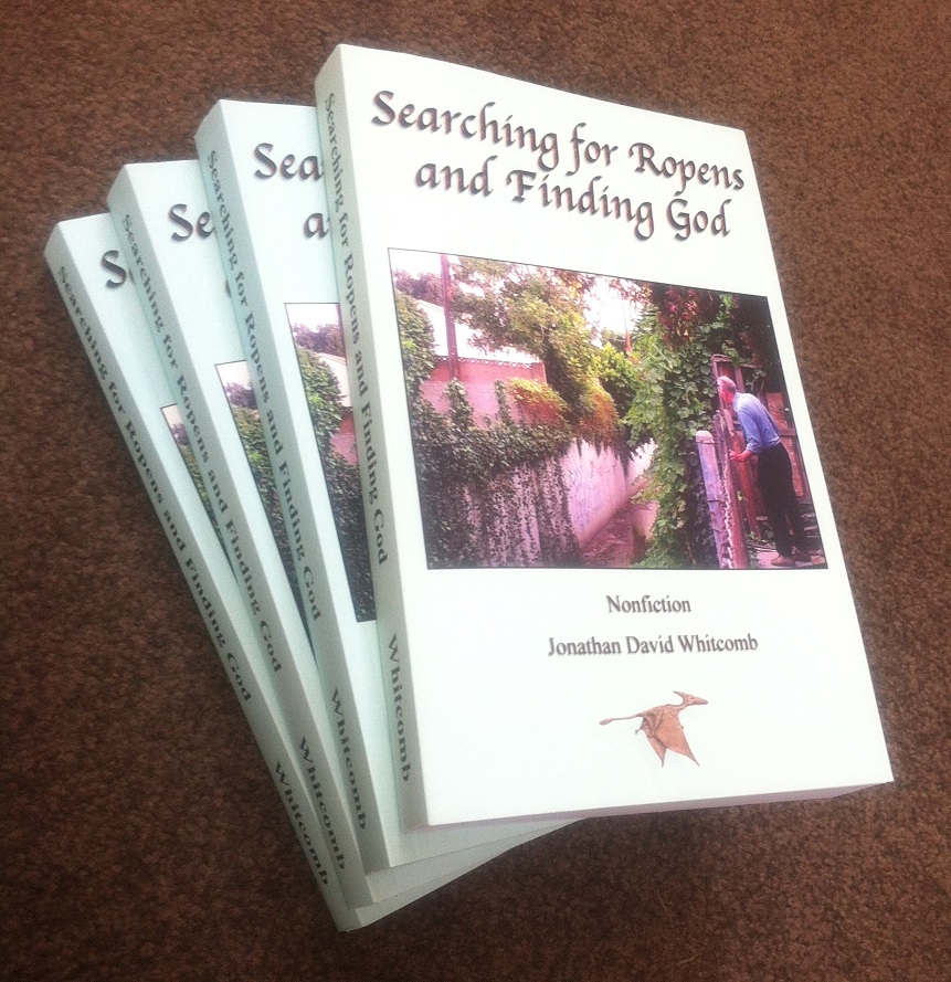 small pile of books: "Searching for Ropens and Finding God" by Jonathan Whitcomb